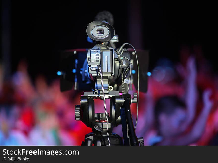 Film camera stays in front of a cheering crowd