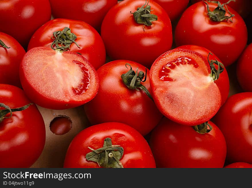 Tasty tomatoes in a box  on white. Tasty tomatoes in a box  on white