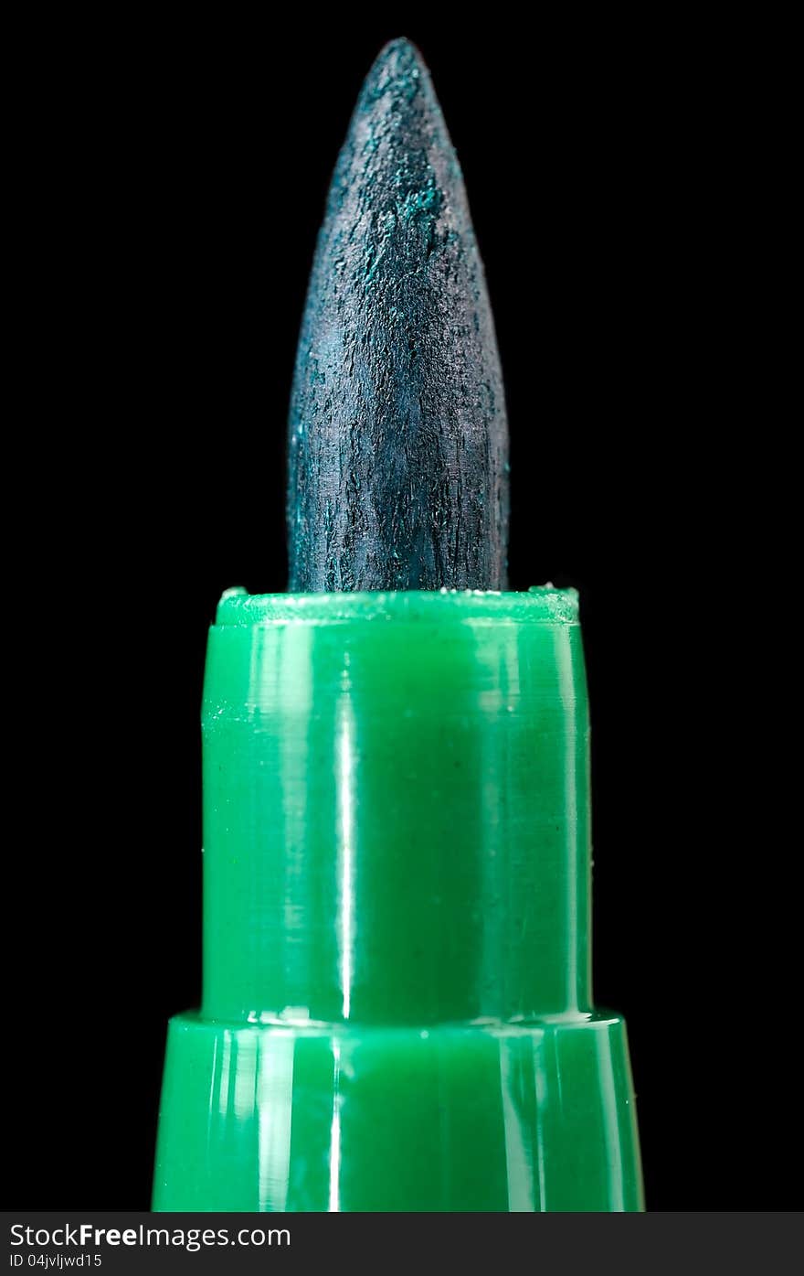 A close-up of a green felt tip pen on a black background. A close-up of a green felt tip pen on a black background