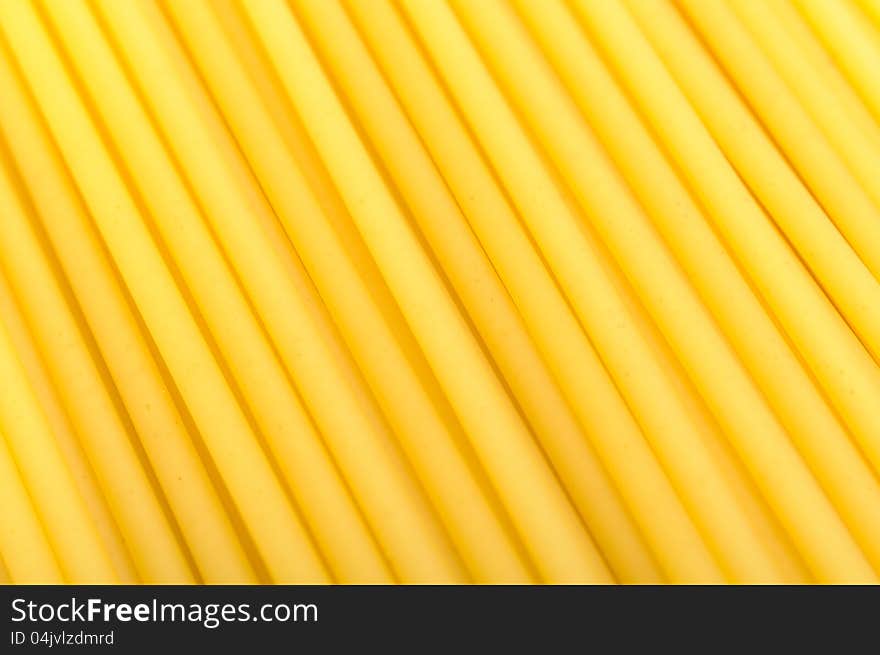 A close-up shot of raw bucatini pasta (long hollow Italian pasta). A close-up shot of raw bucatini pasta (long hollow Italian pasta)