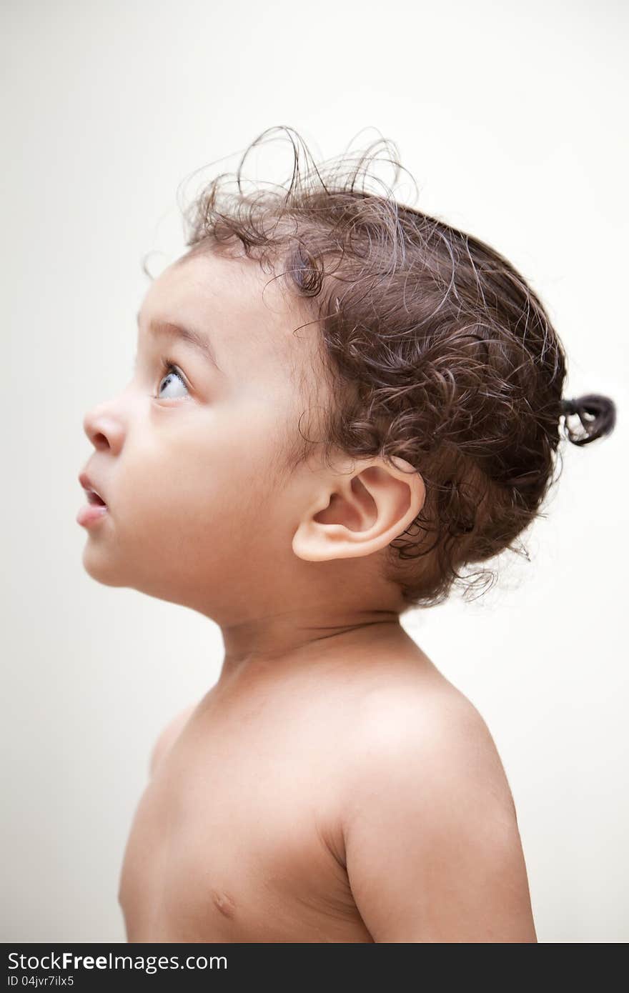 Surprised indian baby boy over white background