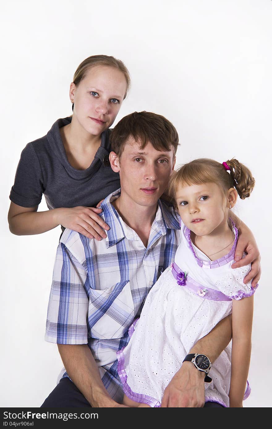 Young European family from three persons - mother, father and daughter. Isolated. Young European family from three persons - mother, father and daughter. Isolated