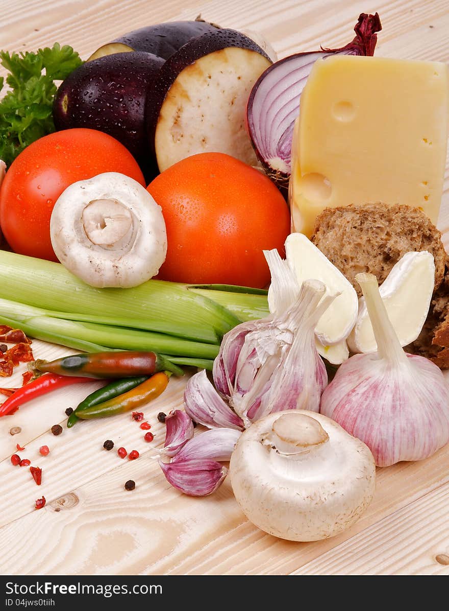 Ingredients and Vegetables with Cheese and Spices closeup on wooden background