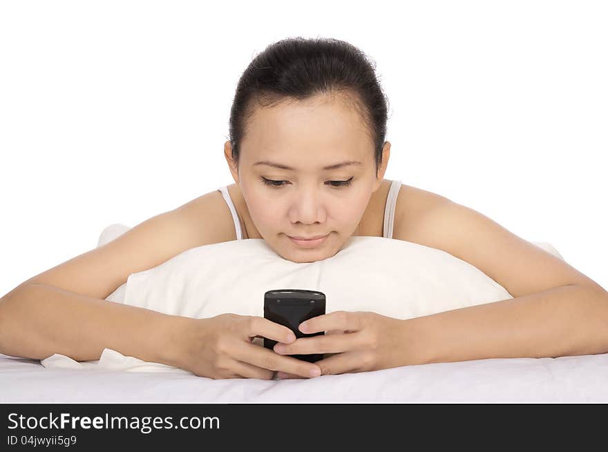 Asian woman send text message to her friend on the bed. Asian woman send text message to her friend on the bed