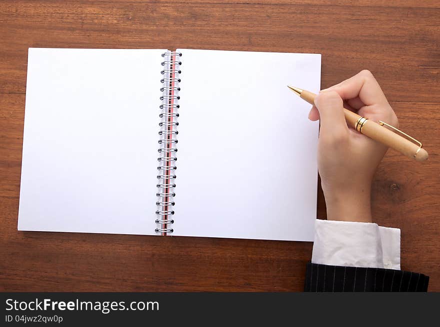 Business woman white something on blank notebook. Business woman white something on blank notebook