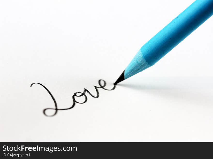 A high key image of blue lead pencil writing the cursive word love on a sheet of paper. A high key image of blue lead pencil writing the cursive word love on a sheet of paper.