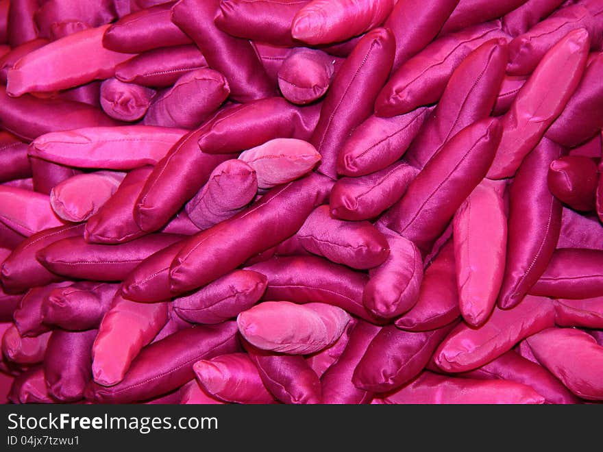 A Background of Sausage Shaped Purple Silk Bean Bags.