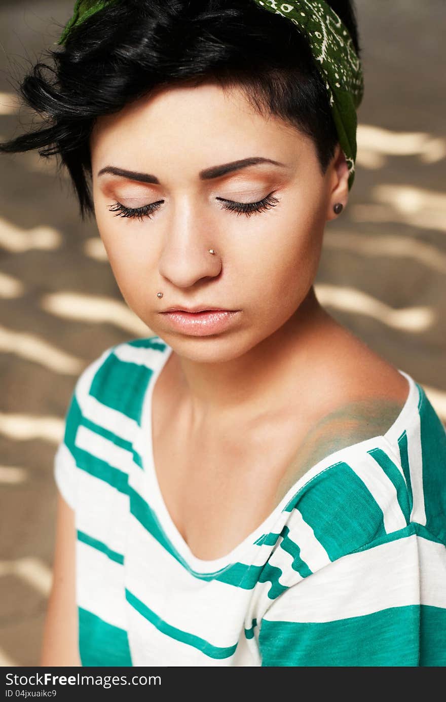 Adorable girl with tattoo on the beach