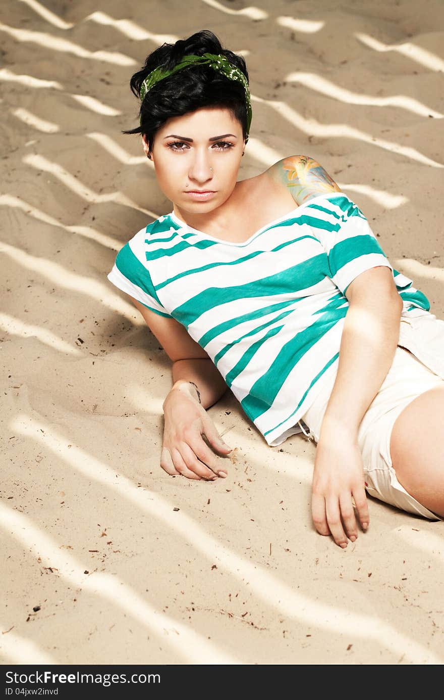 Adorable girl with tattoo on the beach