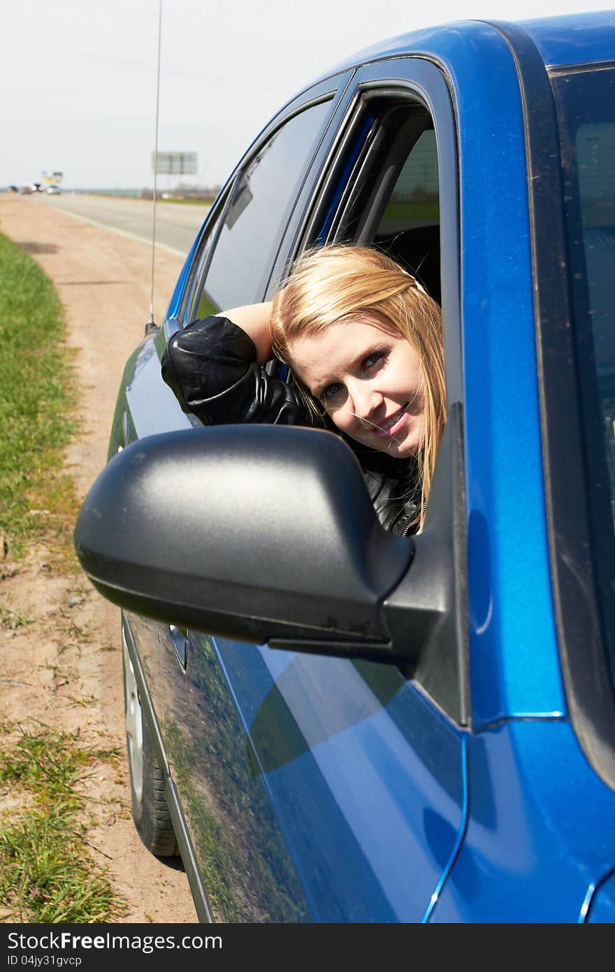 girl in the dark blue car