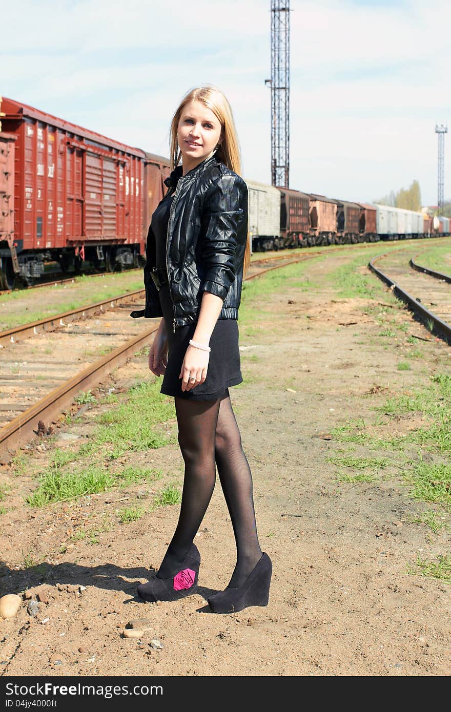 Attractive young girl on railroad tracks