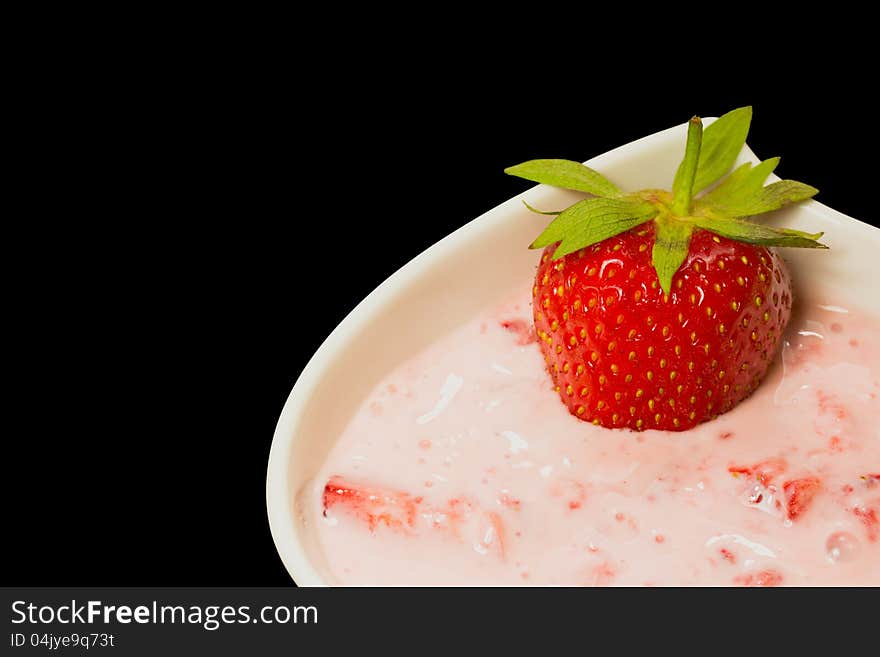 Fresh strawberry with cream . Black background.