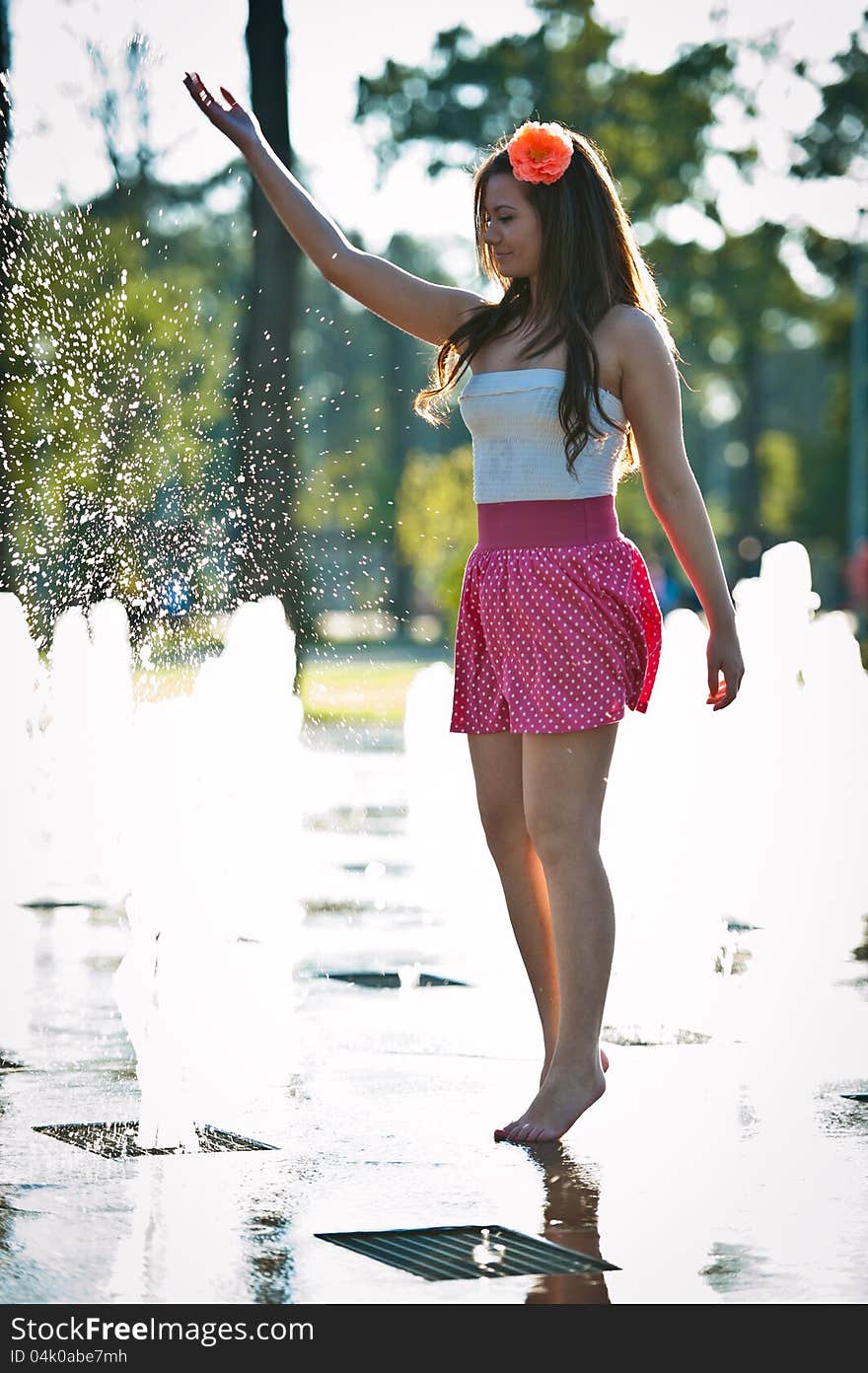 Girl Wearing Red Skirt Playing Water Fountain