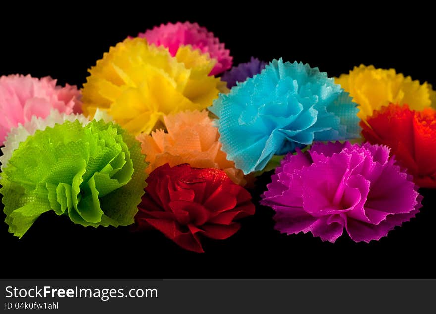 Colorful handcrafted flower on black background