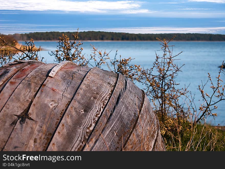 Old row boat in the foreground against blue sea and sky. Old row boat in the foreground against blue sea and sky