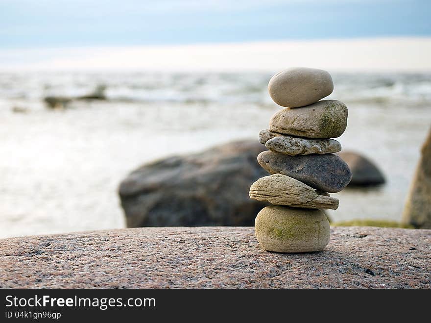 Stack of stones on sea shore in evening light, close up. Stack of stones on sea shore in evening light, close up