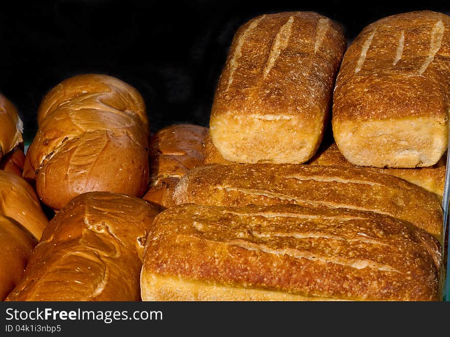 Different kinds of bread loafs stacked. Different kinds of bread loafs stacked