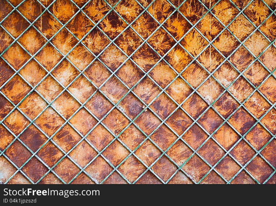 Old rusty fence with a lattice and steel sheet substrate background. Old rusty fence with a lattice and steel sheet substrate background