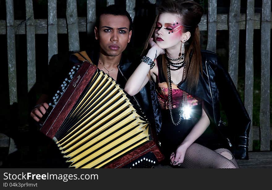 Two young people with accordion flirting. Village. Countryside. Two young people with accordion flirting. Village. Countryside