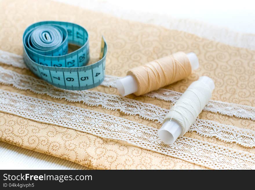 Spools of thread, lace and fabric. Spools of thread, lace and fabric