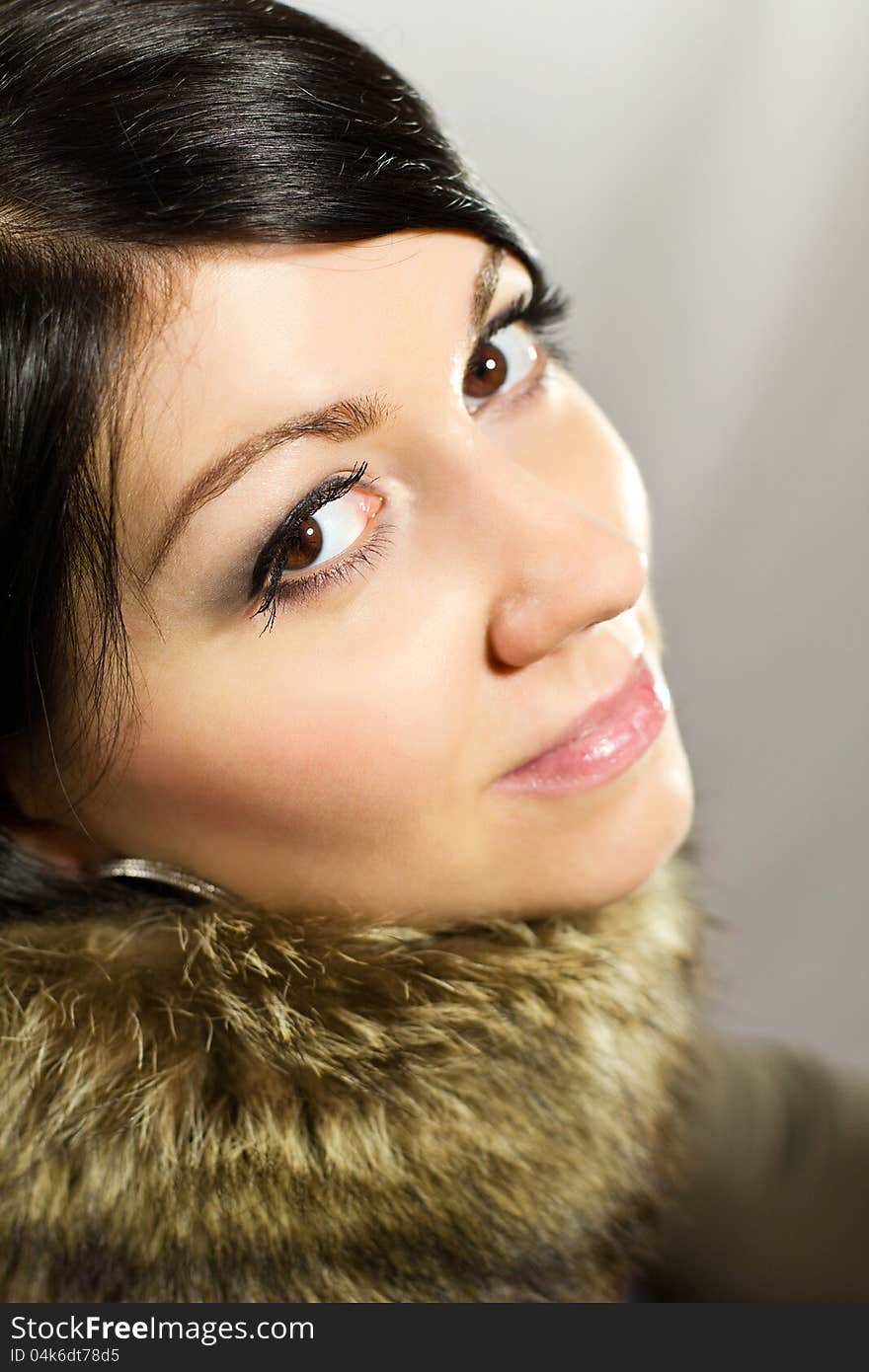 Portrait of a beautiful woman in a fur collar