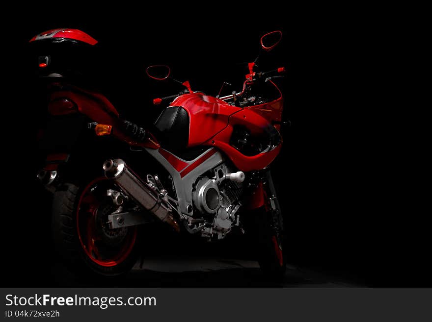 Red sports motorcycle in the dark. Red sports motorcycle in the dark