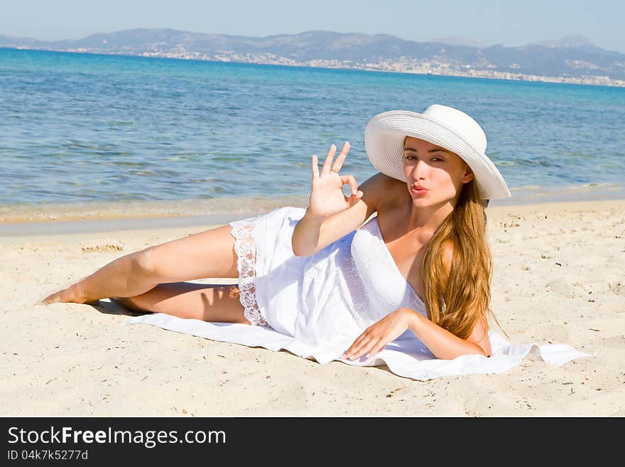 Happy young beautiful woman  on the beach