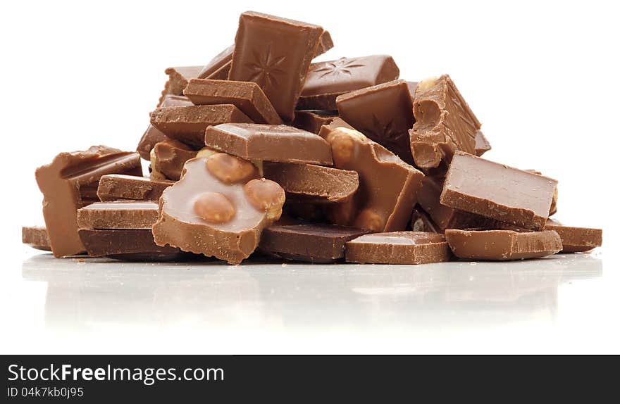 Stack of dark and milk chocolate with nuts  on white background.