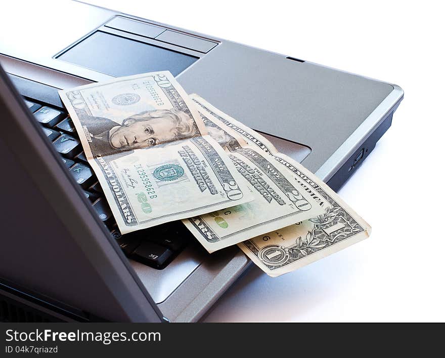 Dollars on the laptop's keyboard. Dollars on the laptop's keyboard