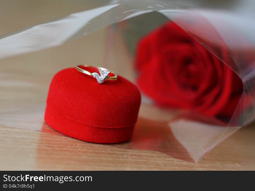 Diamond ring on the red box and red roses in the background