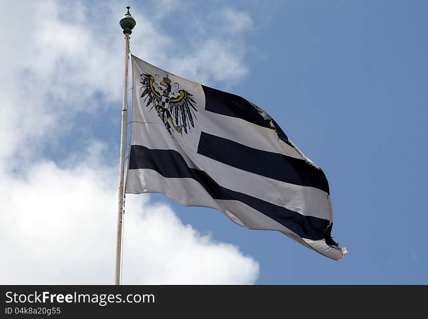 Flag of the German royal family of Hohenzollern flying in the wind with cloudy background. Flag of the German royal family of Hohenzollern flying in the wind with cloudy background.