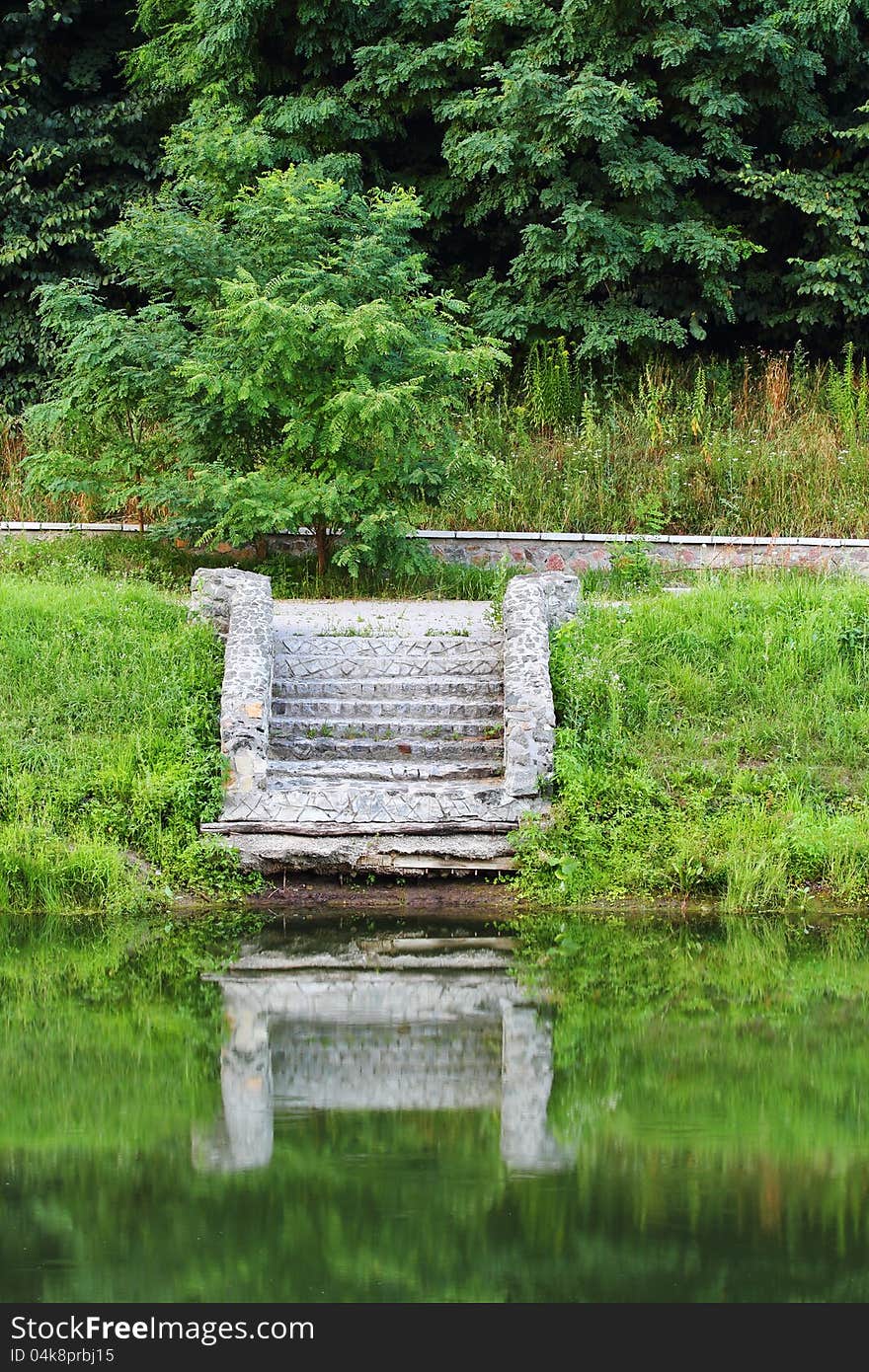 Stairs by the water with reflection in it