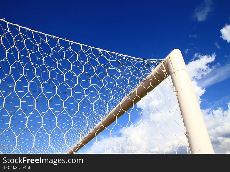 Soccer goal corner with net and blue sky with clouds. Soccer goal corner with net and blue sky with clouds