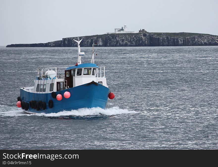 A Boat Returning to Harbour Past the Lighthouse. A Boat Returning to Harbour Past the Lighthouse.