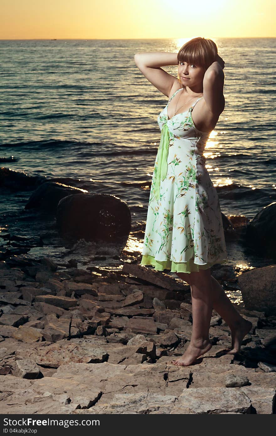 Beautiful girl by the lake at sunset. Beautiful girl by the lake at sunset