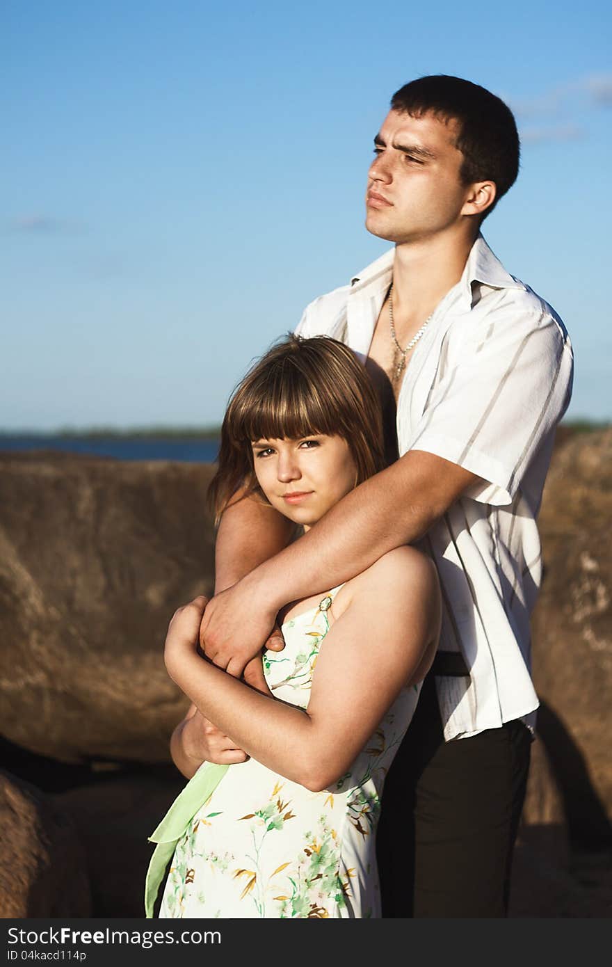 Serious guy hugging his beloved beautiful girl. Serious guy hugging his beloved beautiful girl