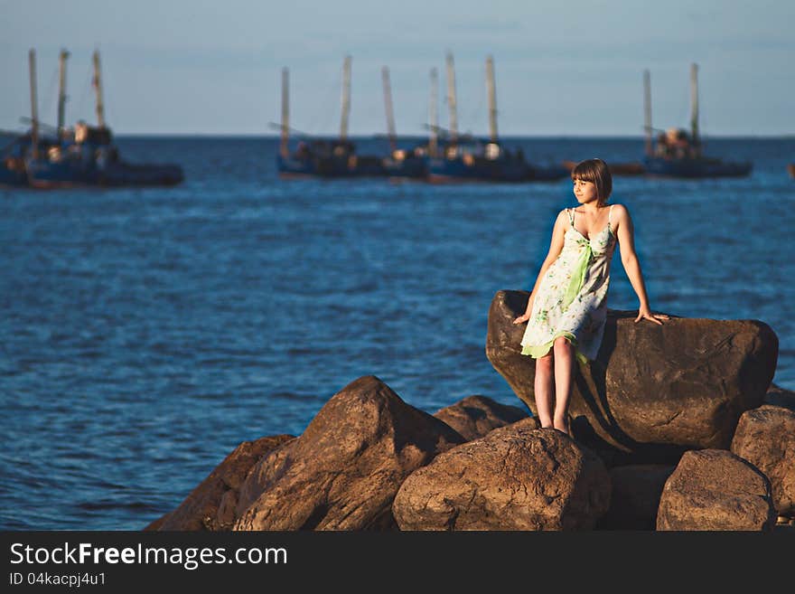 Beautiful lonely girl on the lake