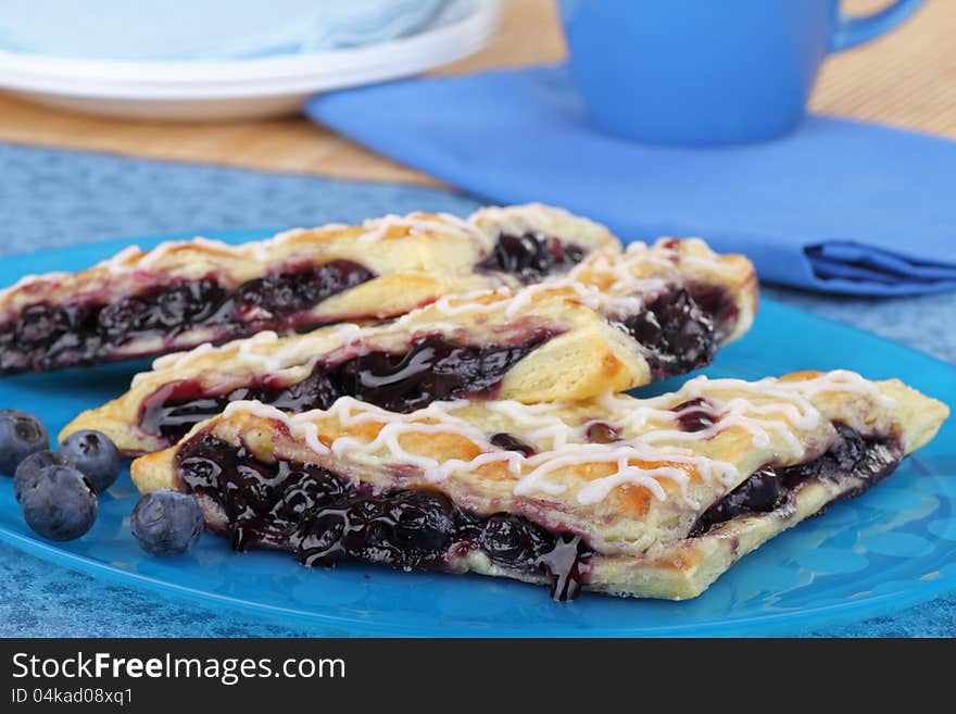 Blueberry turnovers with berries on a platter