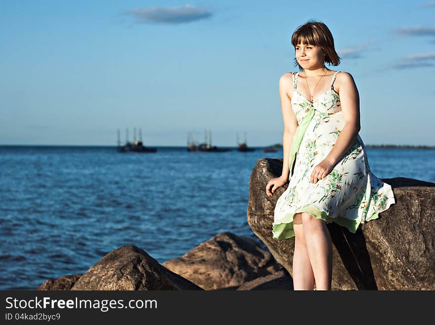 Beautiful lonely girl on the lake