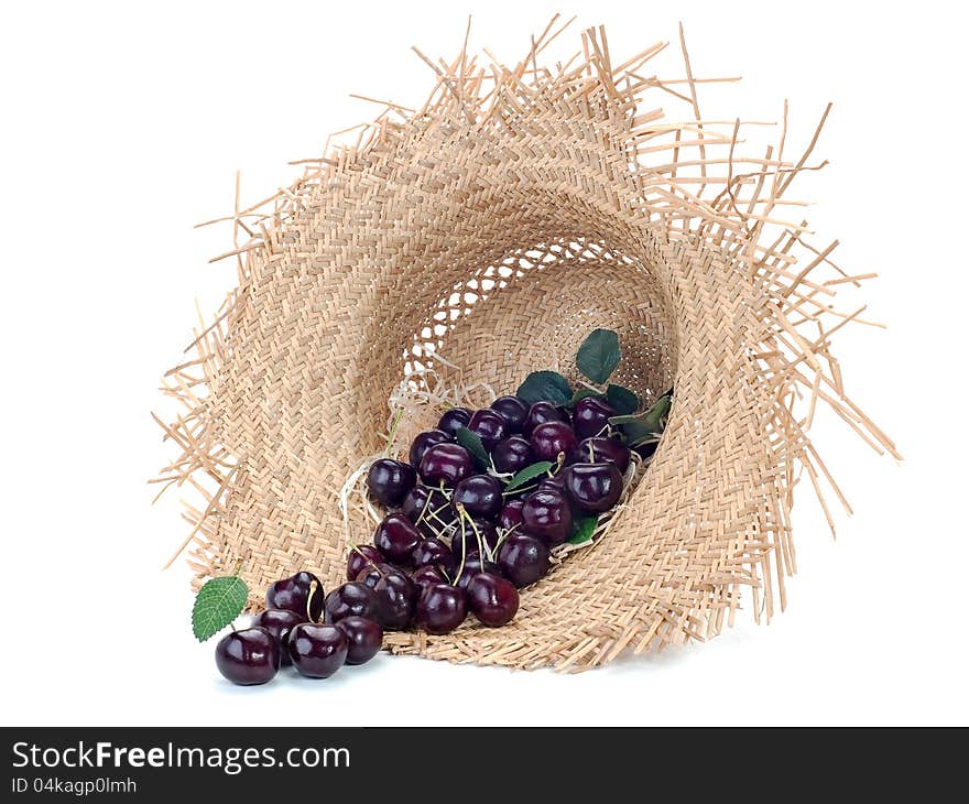 Sweet cherry in a straw hat on white