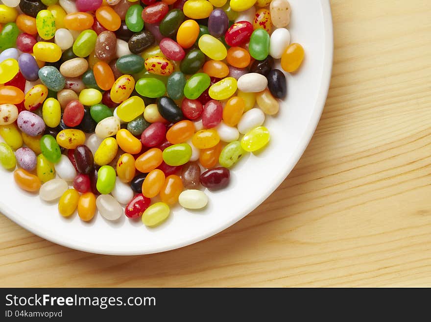 Colourful jelly beans in bowl on table