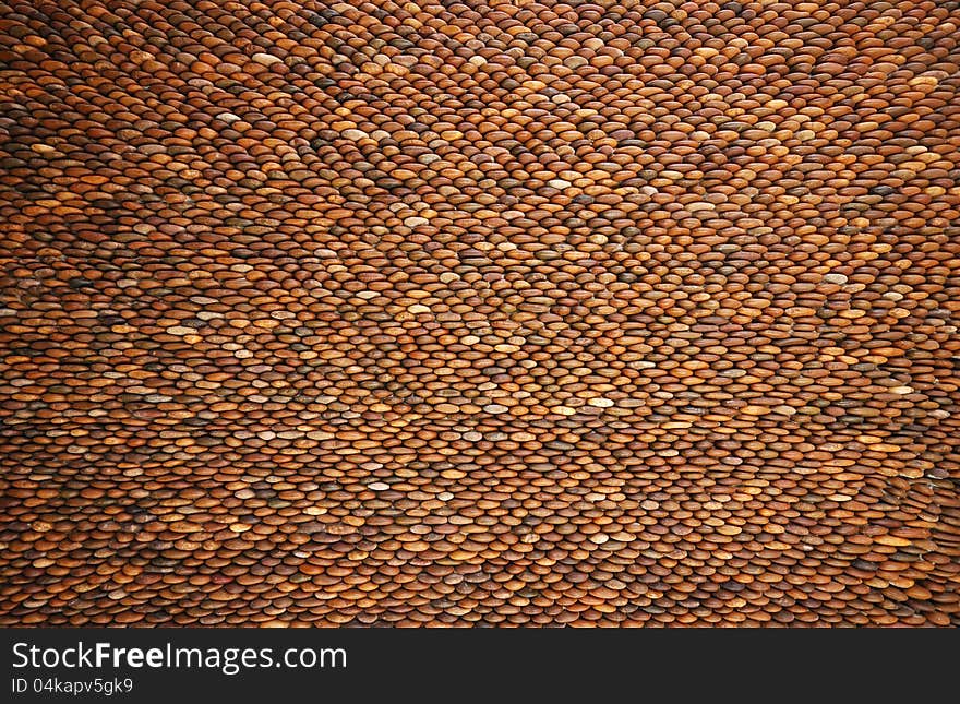 Pebbles stone wall brown texture. Pebbles stone wall brown texture