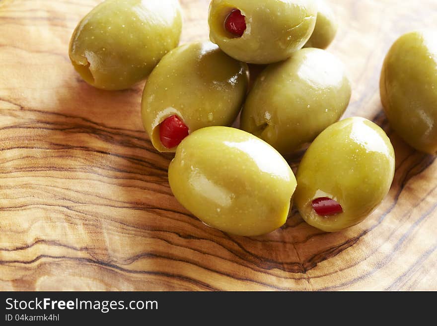 Green olives on olive wood platter