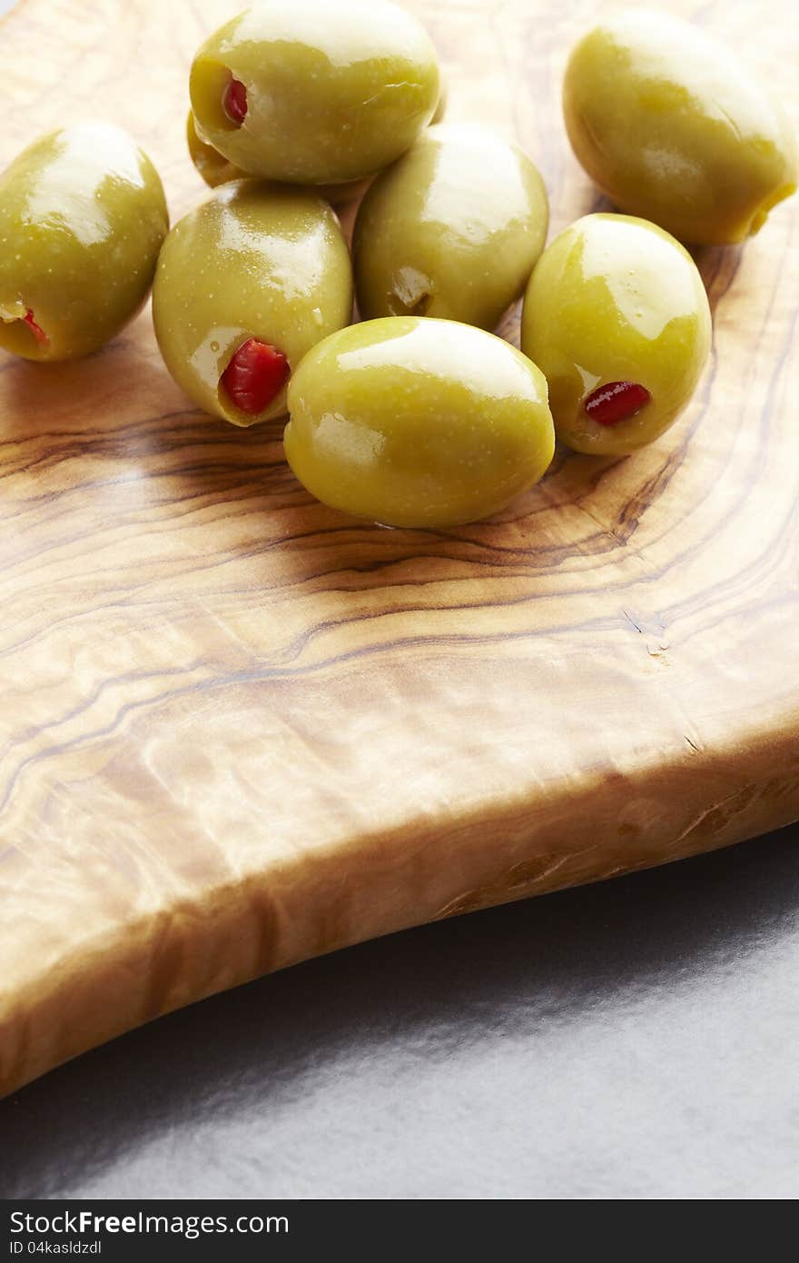 Green olives on olive wood platter