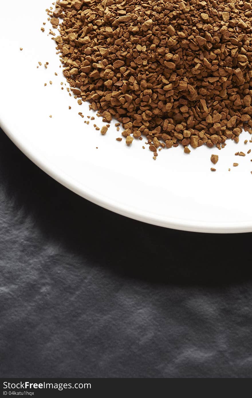 Instant coffee granules on white plate