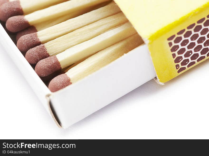 Matches in a yellow match box on white background. Matches in a yellow match box on white background