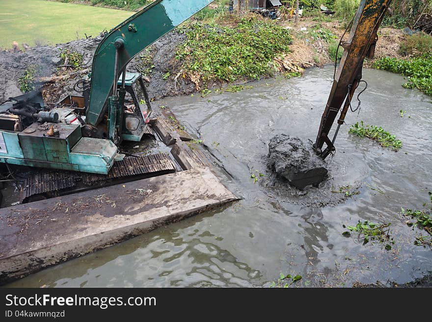 Dredging the canal, Backhoe in the pontoon, working in the canal