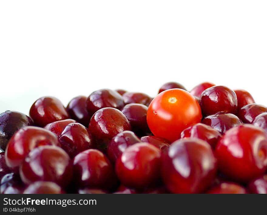 Cherry tomato with cherries look similar. Cherry tomato with cherries look similar