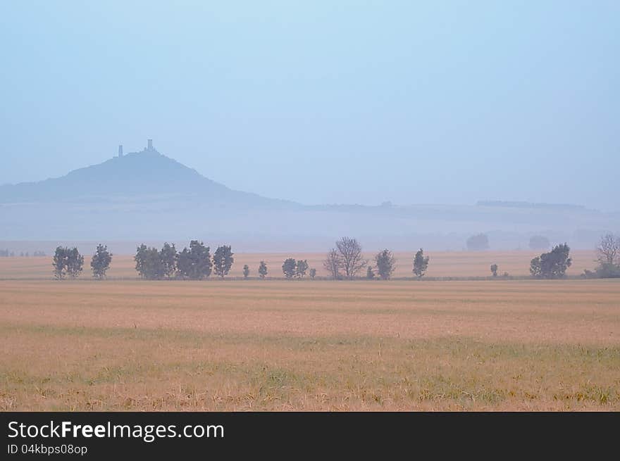 Morning landscape with a castle and a mist in the background. Morning landscape with a castle and a mist in the background