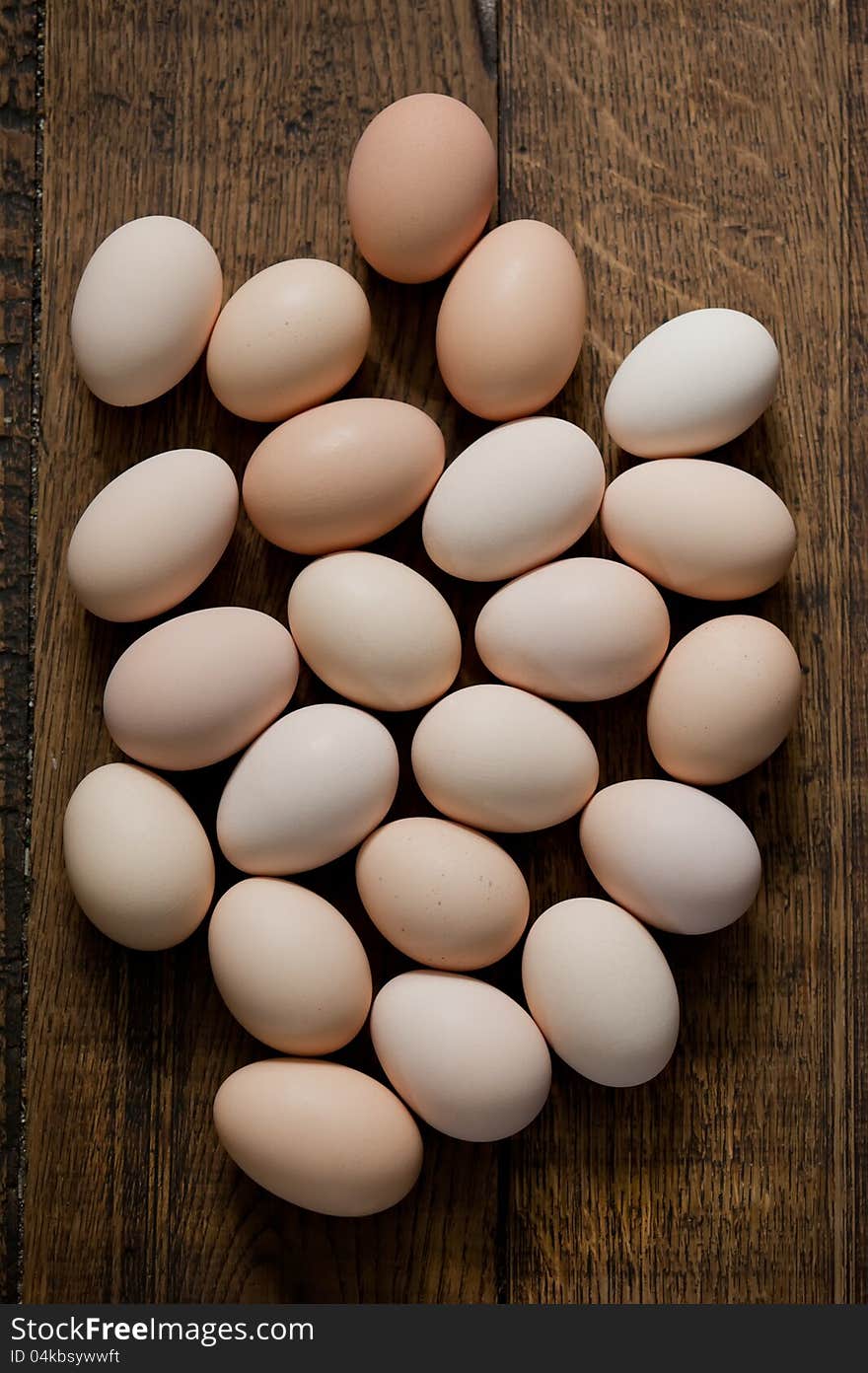 Brown eggs at wooden table background. Shallow depth of field